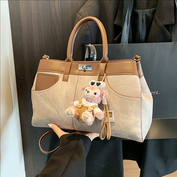 Bolso de mano retro de otoño y invierno para mujeres 2025 nuevo estilo de alta calidad de la bolsa de transporte de viaje empalmado bolso de hombro