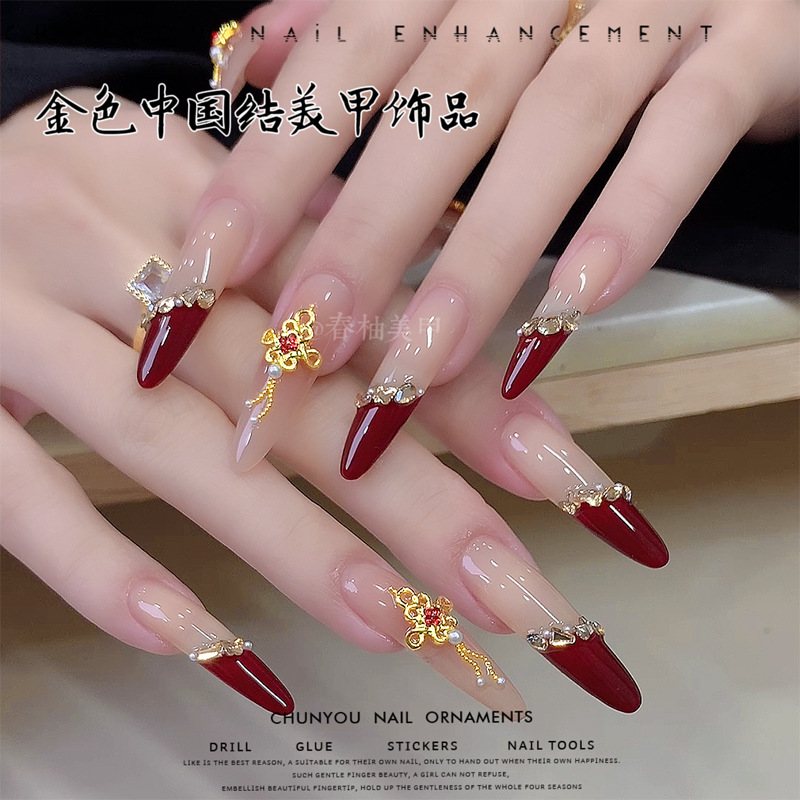 Nuevos joyas de uñas de oro de China marcha nacional con diamantes rojos accesorios de uñas de Año Nuevo taladro