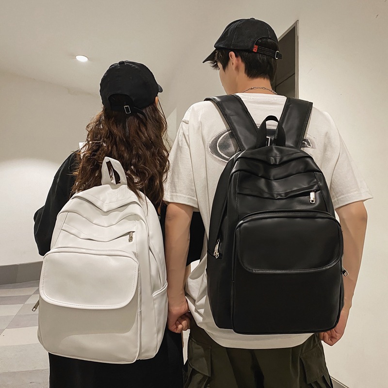 Comercio exterior al por mayor 2023 nueva versión coreana de la mochila de cuero suave para estudiantes de secundaria Mochila de computadora de gran capacidad de color sólido de moda