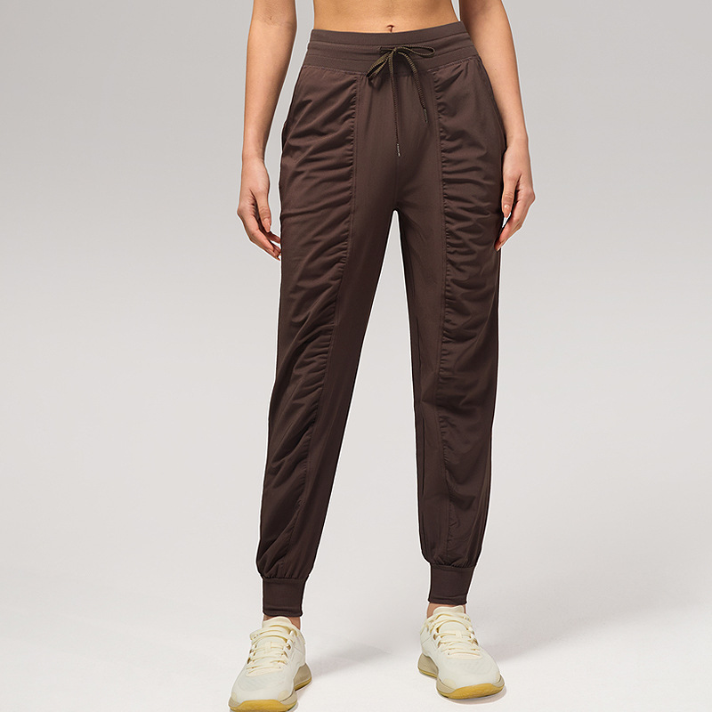 Pantalones deportivos casuales sueltos de mujer plegados para correr pantalones de yoga de nueve puntos de bolsillo secado rápido pantalones de pies transpirables