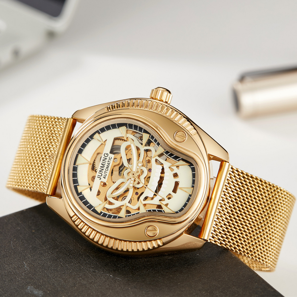 JUNMING Suiza productos genuinos moda impermeable reloj de los hombres correa de acero luminoso reloj mecánico automático cráneo hueco