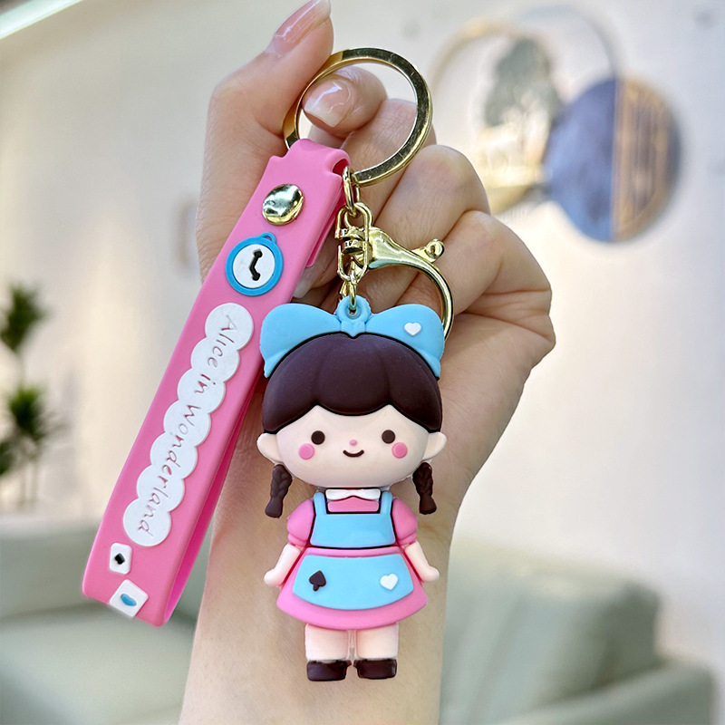 Muñeca de goma goteando bolsas escolares colgantes colgantes de muñecas colgantes de la máquina del mercado nocturno regalos al por mayor llaveros de dibujos animados