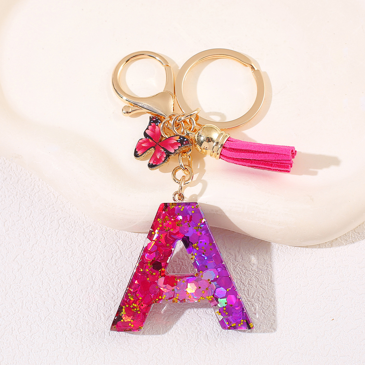 Transfronterizo Amazon 26 letras llavero de goteo de goma esquinilla gradiente letras mariposa llavero bolso de mujer colgante
