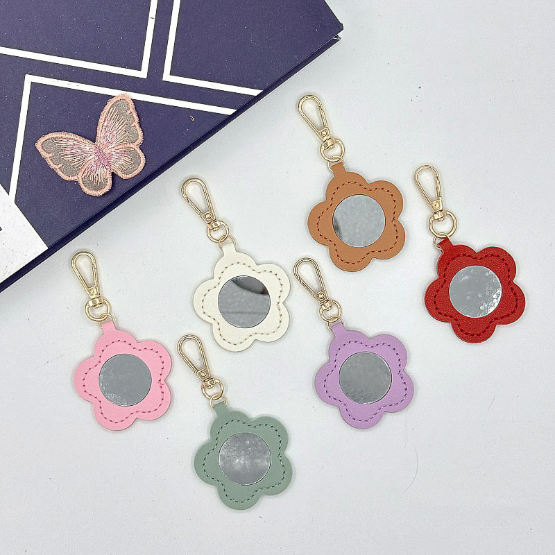 Flor espejo llavero cuero transfronterizo regalo colgante joyería creativo mini lápiz labial almacenamiento llavero colgante