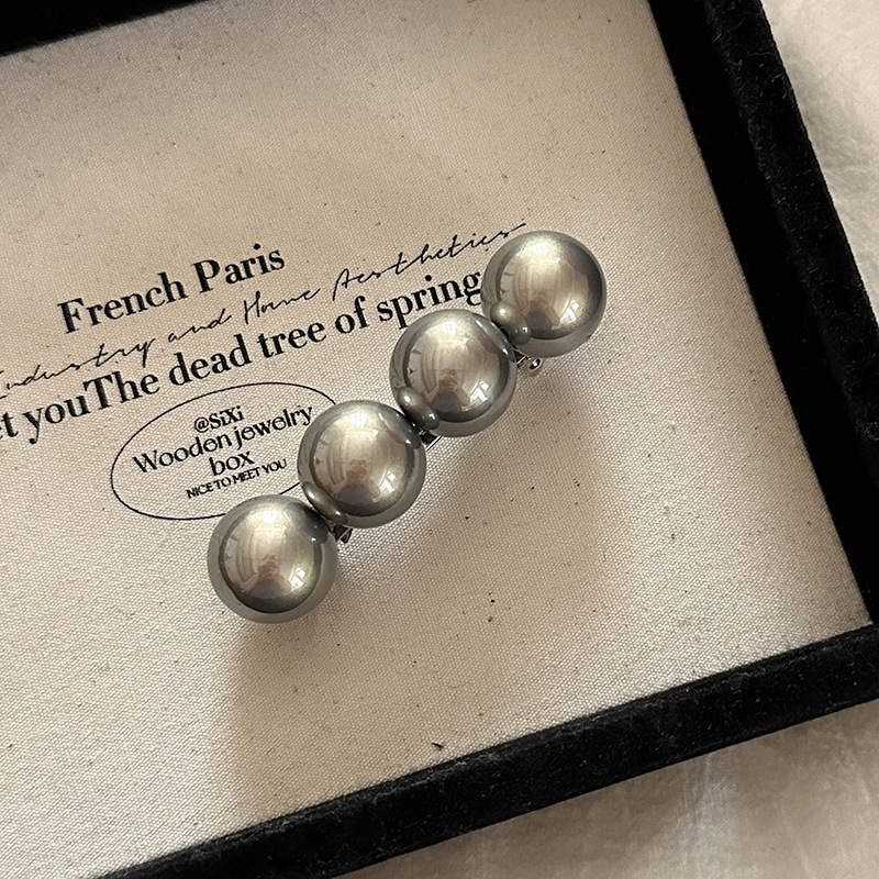 新商品の高級感のある大粒の真珠の一字のスプリングはシンプルな気質の髪飾りを挟みます。