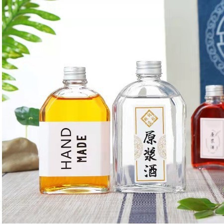 現物卸売りの斜め肩の飲み物の瓶のアーチ形の平瓶のジュースのコーヒーの瓶の小さい酒の瓶の新型のテイクアウトミルクティーのガラス瓶|undefined