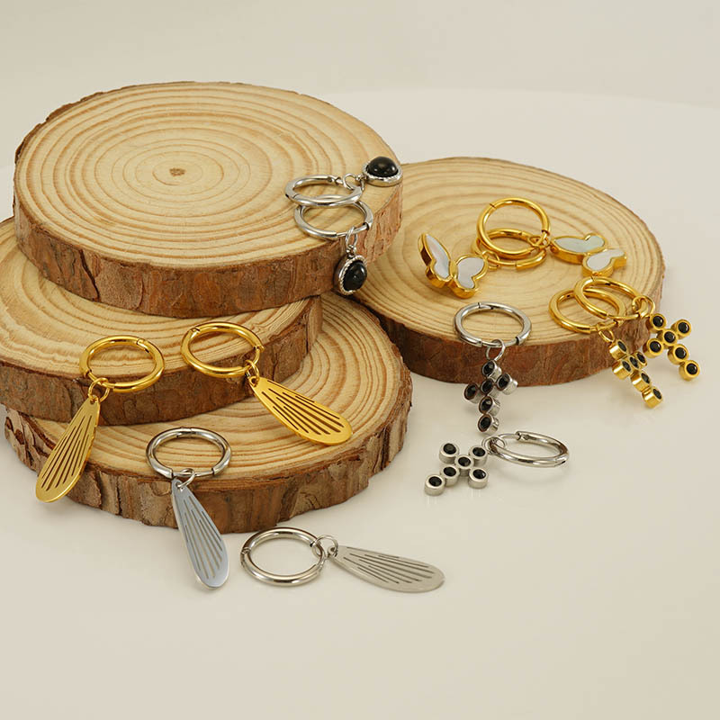 Cruz-frontera nuevo diseño de acero inoxidable hueco Alas pendientes hembra Europea y Americana nicho mariposa Cruz pendientes al por mayor