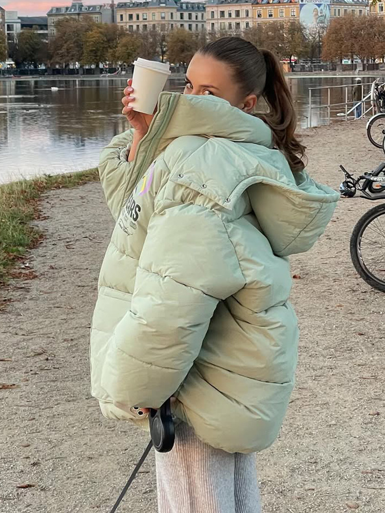 Temperamento de moda ocio de color sólido con sombrero de manga larga bolsillo abrigo de algodón 2025 otoño y invierno nuevo estilo europeo y americano transfronterizo