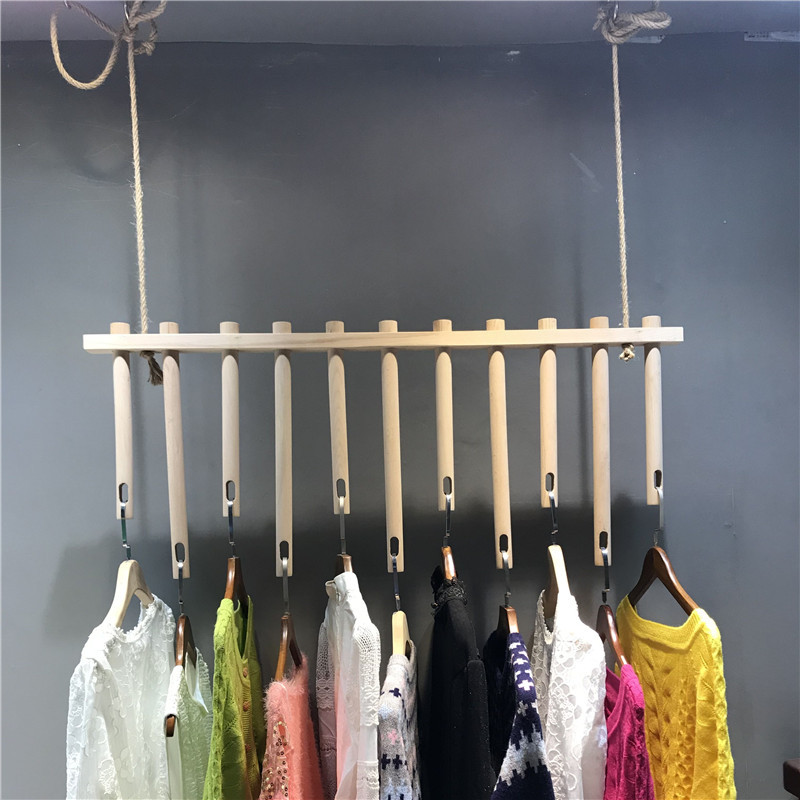 Clothing store display racks, wall-mounted, ceiling-mounted, suspended solid wood shelves, wall-mounted side-hanging clothes with hanging rings and ropes.