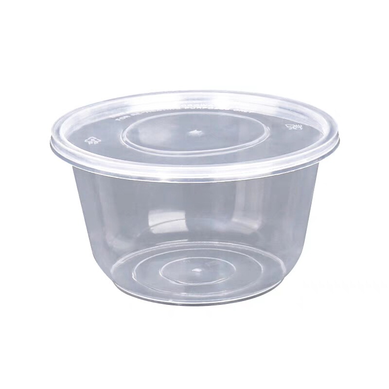 使い捨ての碗の円形の透明な弁当箱の食器は蓋がついています。|undefined
