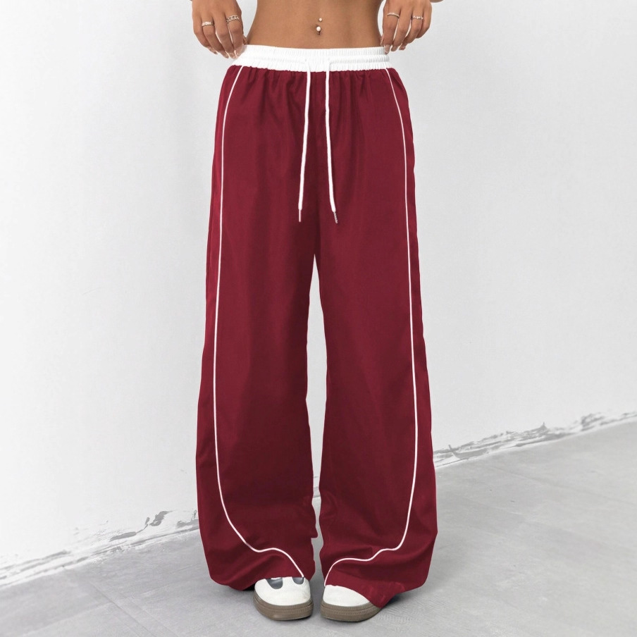 Europa y los Estados Unidos transfronterizos de otoño y invierno 2025 moda nuevos pantalones deportivos negros de mujer sueltos ociosos nichos de piernas largas