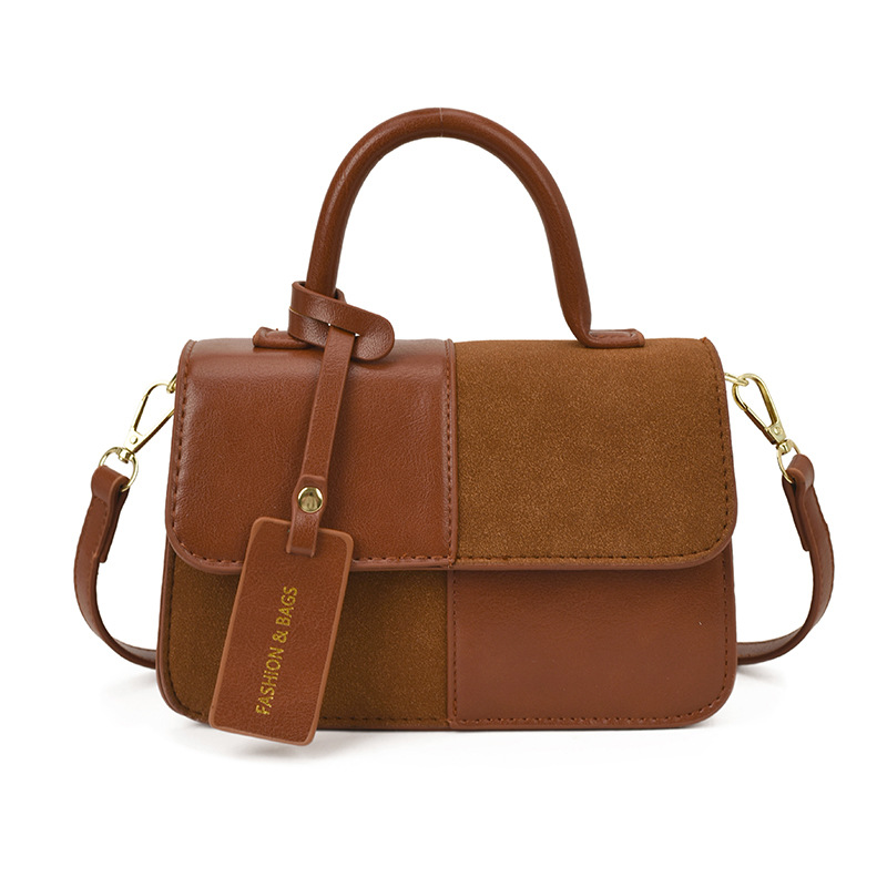 Bolsos de mano de textura alta para mujeres 2025 nueva tendencia europea y americana cruzada retro empalme versátil mochila