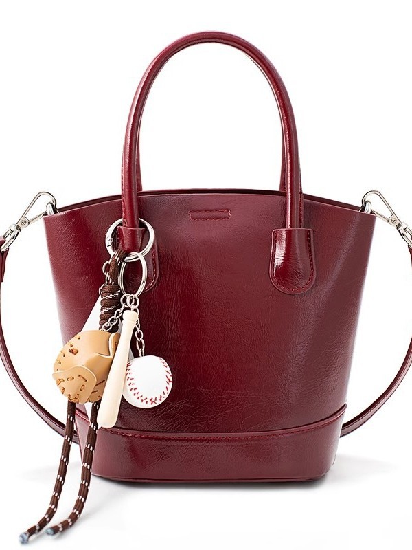 Alta sensación retro bolso de cubo rojo para mujeres otoño / invierno 2025 nuevo nicho bolso de novia bolso de mano de viaje mochila