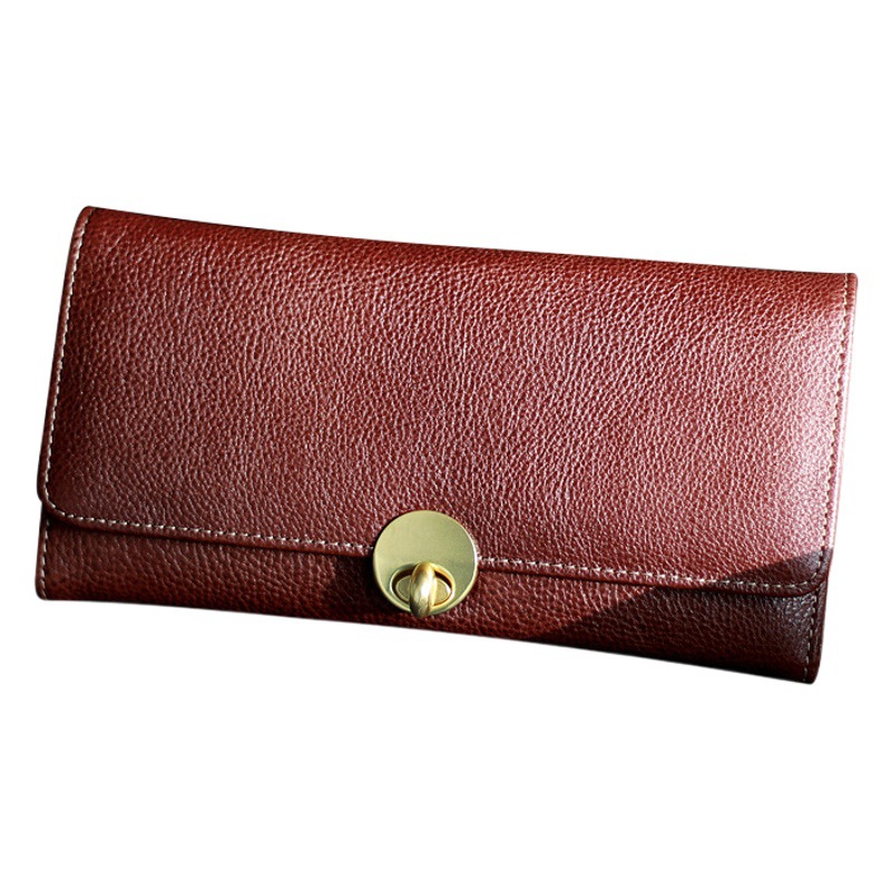Cartera de cuero 2025 nueva billetera de mujer larga y delgada capa superior piel de vaca simple billetera de doble pliegue con cerradura retro europea y americana