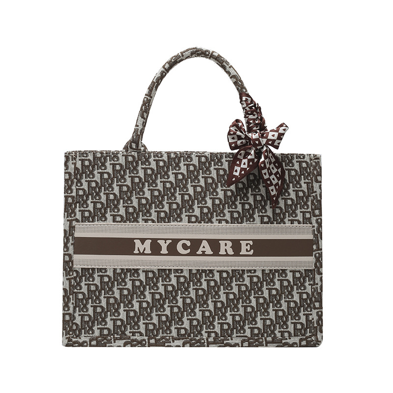 Bolsos bordados de alta calidad para mujeres 2026 nuevas letras de tela transfronterizas retro bolsas de mano de transporte de gran capacidad