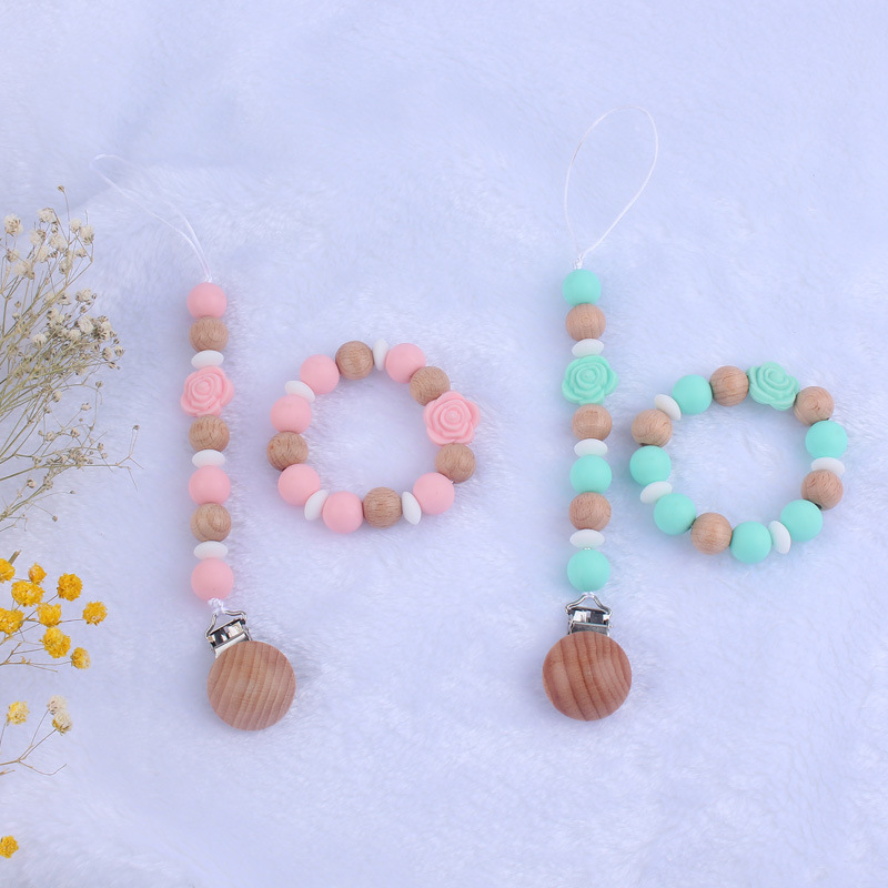 Nuevo bebé de dibujos animados de silicona de doble cara Rosa mordedor calmante bebé anti-gota cadena pulsera traje de juguete