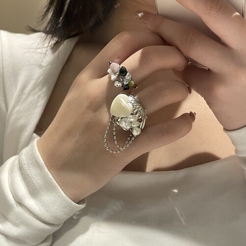 A versatile and lightweight luxury ring for women featuring freshwater pearls, designed in a French Baroque style with a shell tassel, exuding a sophisticated and elegant charm.
