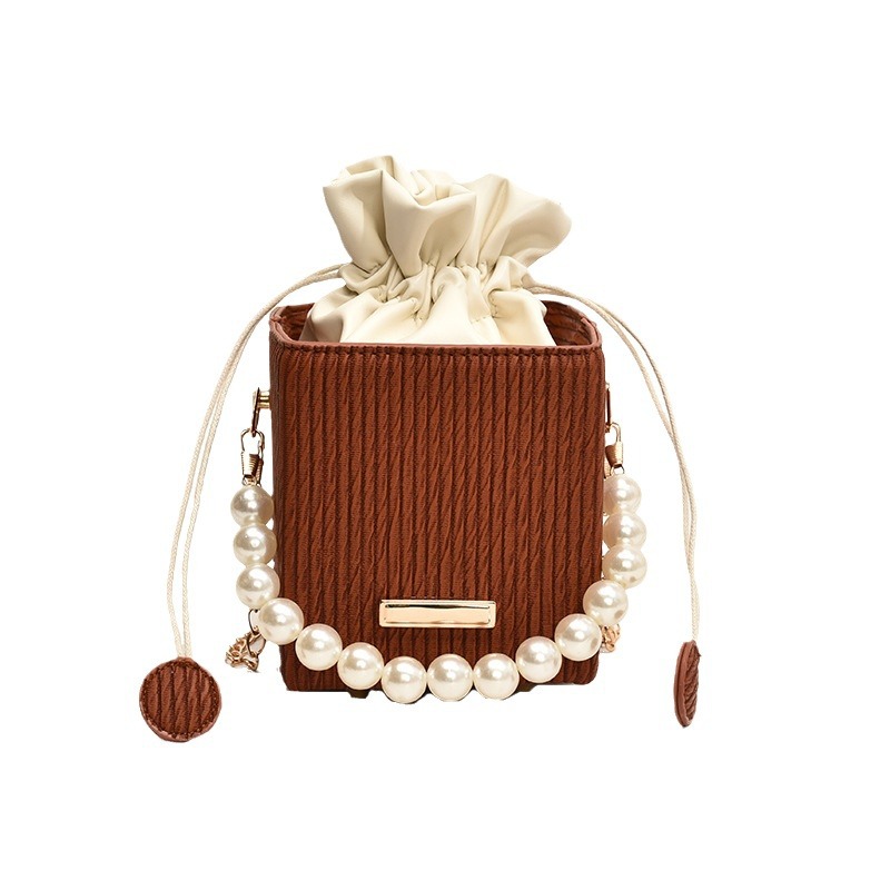 Una pequeña cadena de viento de fragancia tejida simple mochila casual, estilo de viaje coreano mini bolso de cubo, bolso de perla