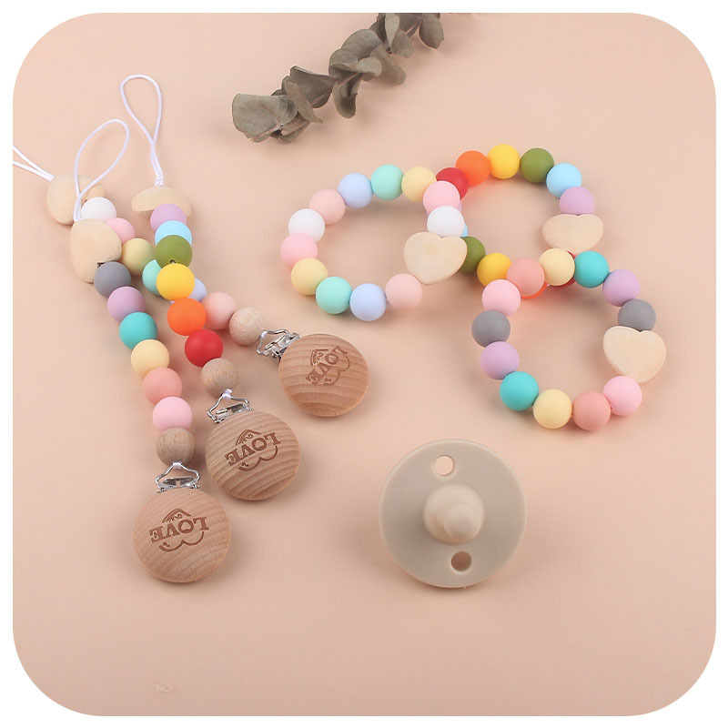 Comercio exterior nuevo bebé suministros mordedor pulsera chupete cadena traje bebé amor madera chupete cadena anti-caída
