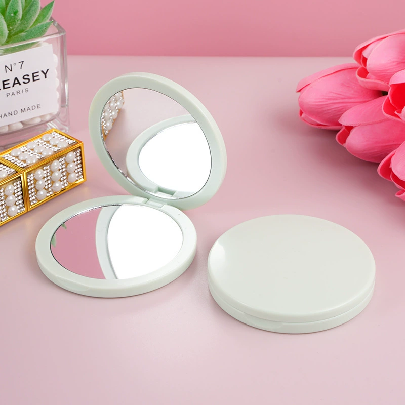 Folding handheld round mirror, double-sided plastic 7.2 cm, magnetic, 2× magnification
