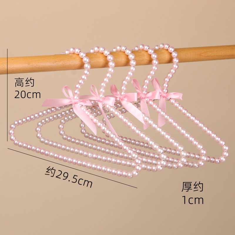 Tienda de ropa de mujer perla lujo ligero vestido retro arco adulto percha de ropa infantil estilo europeo hadas soporte de abrigo