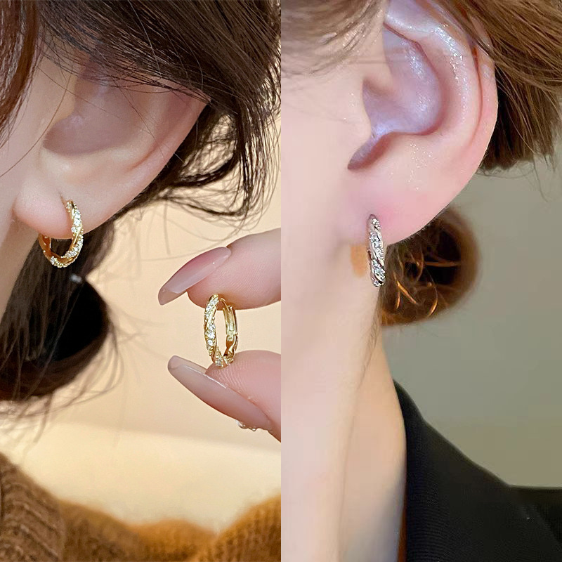 Fashionable golden earrings with zircon