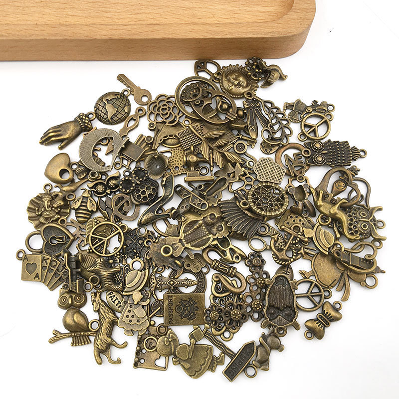 100個の混合レトロなイヤリングのネックレスのアクセサリーの古い青銅の小さいペンダントのdiy材料の合金の部品は鏡にまたがります。|undefined