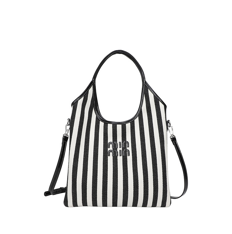 Bolsa de hombro a rayas de lona 2026 nueva sensación de lujo ligera casual diaria gran capacidad mochila