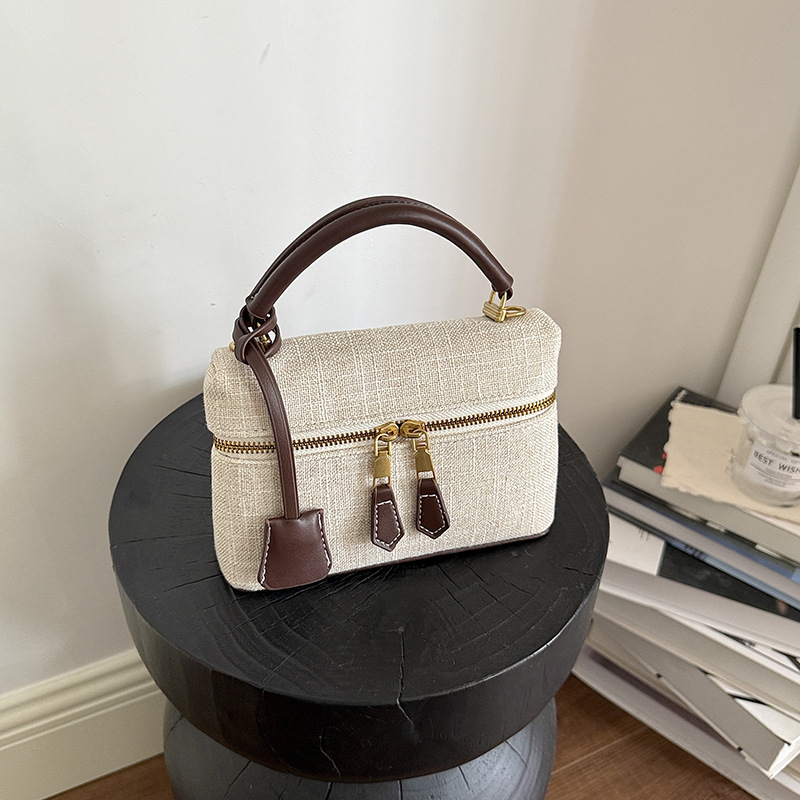 Bolso de mano de alta sensación para mujeres 2026 nuevo nicho zhong lino bolsa de almuerzo de viaje transfronterizo mochila pequeña bolsa
