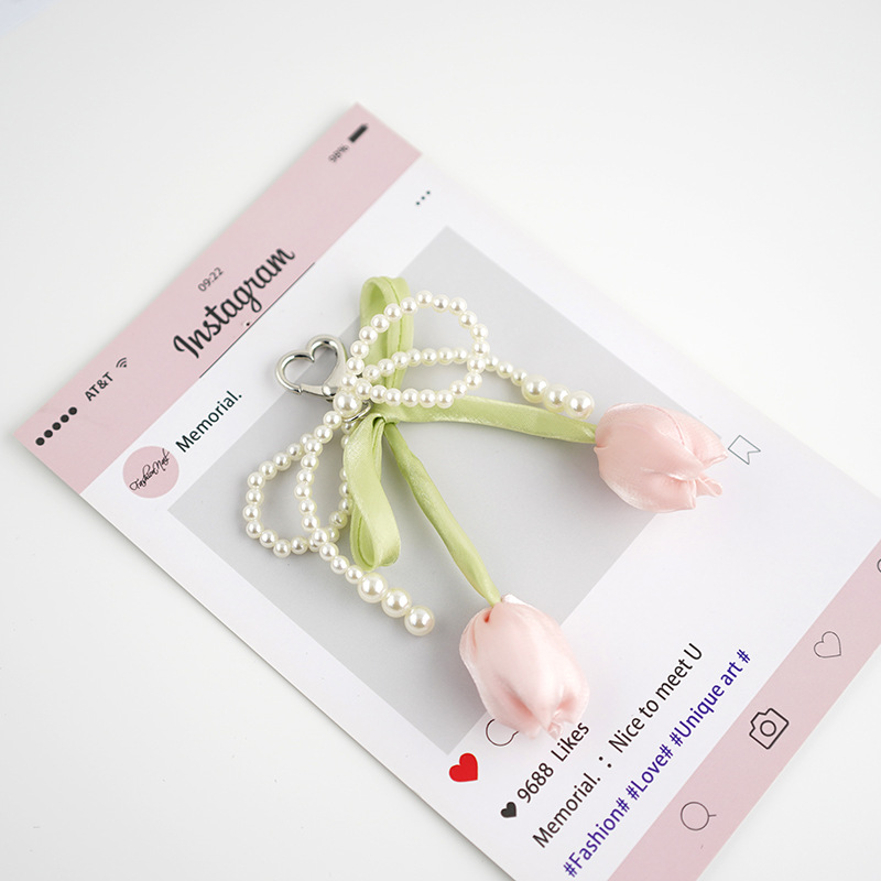 Venta caliente todo fósforo tulipán perla rosa serpentina arco púrpura colgante amor llavero bolso colgante