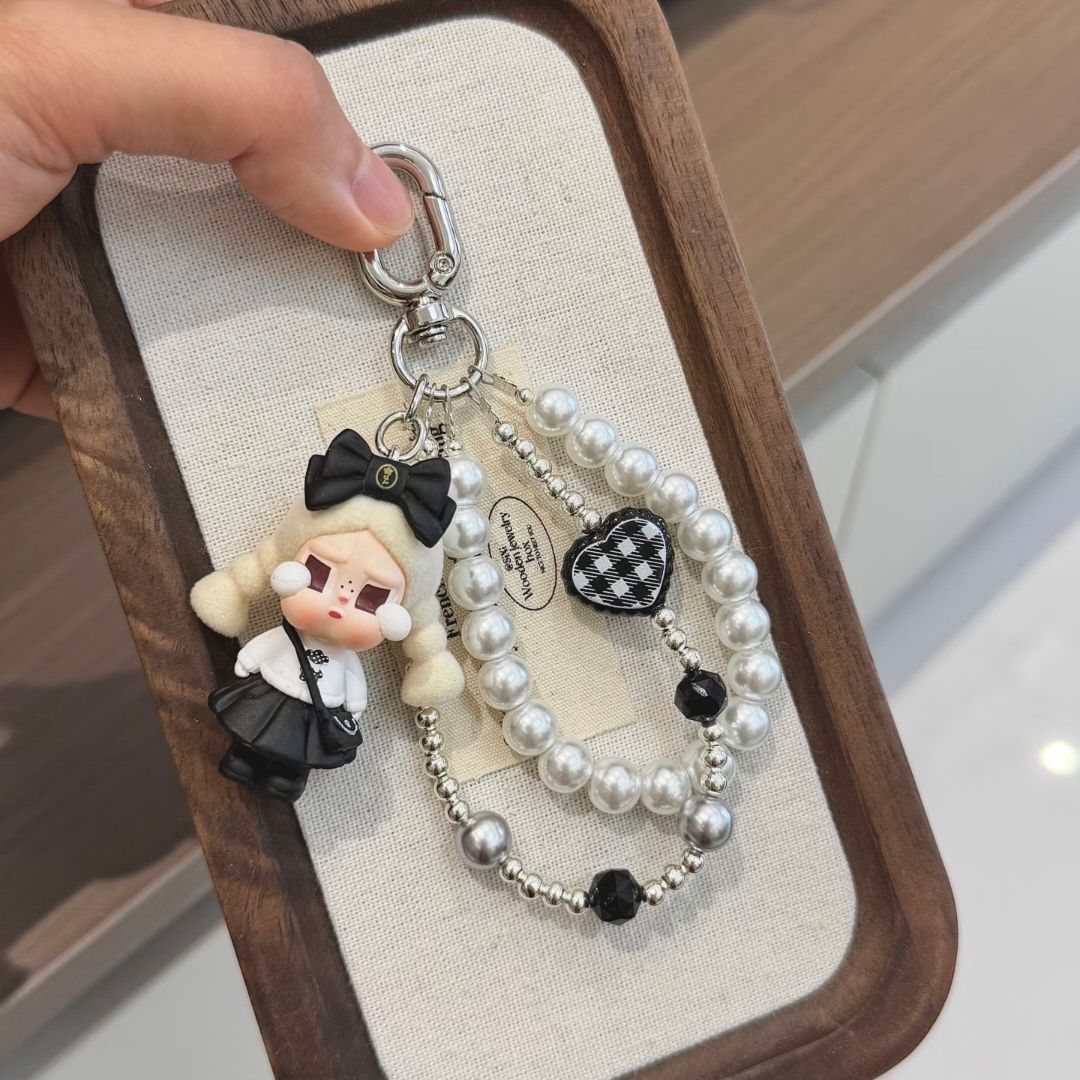 Sweet and cool black and white small fragrance style phone chain with double ponytail, bow, doll, heart, pearl beads, and CCD camera charm
