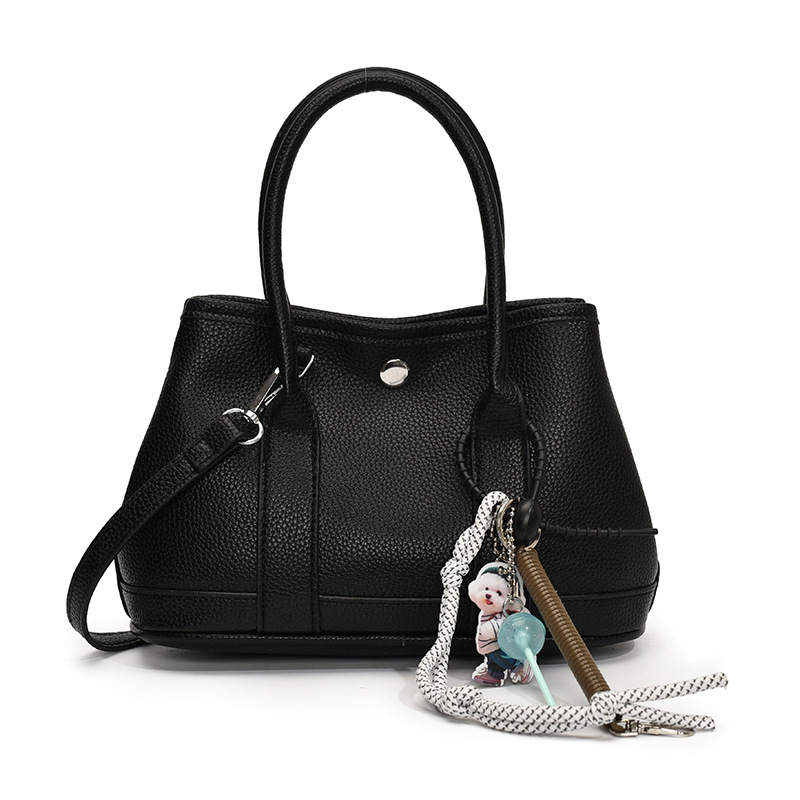 Nicho de moda explosivo bolso de cubo portátil para mujeres 2025 nuevo estilo universal simple bolso de mochila de moda extranjera bolso de mochila