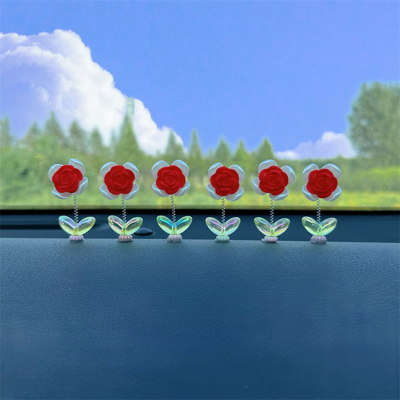 Tendencia nuevo producto flocado rosa coche sacudiendo la cabeza pequeños adornos decoración de primavera tablero accesorios de coche ventana
