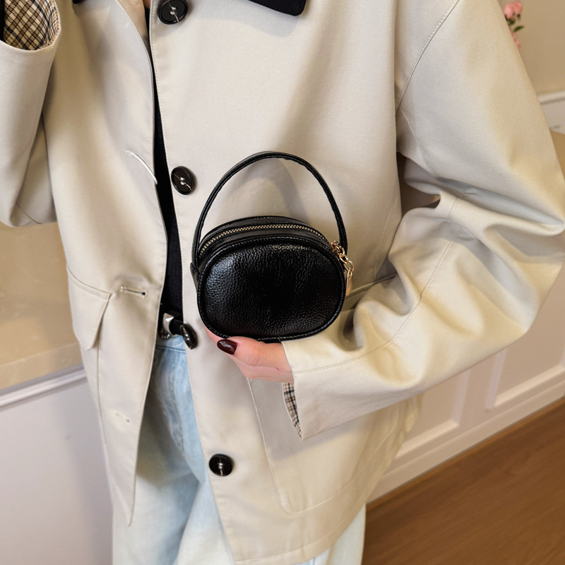 Bolso de mano de niña láser brillante simple color sólido mini bolso de cambio de bebé coreano nuevo bolso infantil transfronterizo