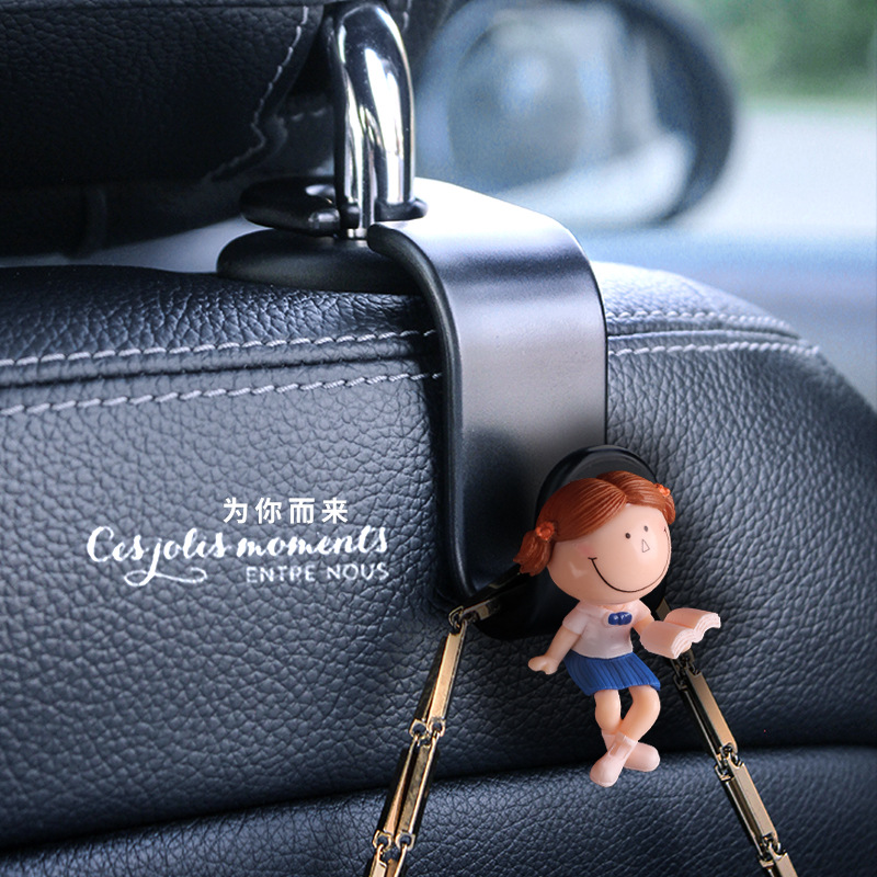 Accesorios interiores de automóviles transfronterizos gancho trasero gancho de asiento de automóvil pareja encantadora lectura de dibujos animados muñeca popularidad en línea