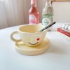 Xinming's new smiley cup hand pinch ceramic cup disc house coffee cup breakfast cup disc dec of the disk set set