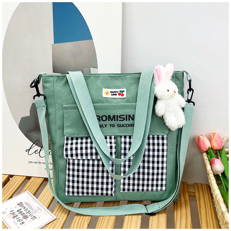 The new Korean-style cute nylon bag for class tutoring is a versatile checkered single-shoulder bag that is selling well (with a bear) undefined