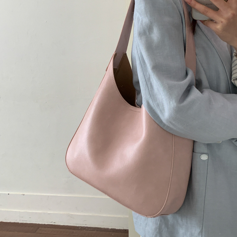 Nicho de diseño simple bolso de cubo portátil para mujeres 2026 primavera nueva moda perezosa retro bolso de brazo diario