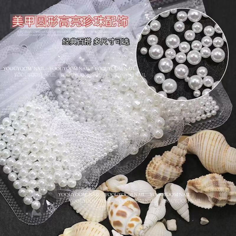 Joyas de manicura de perlas blancas puras no se desprenden de la piel de la bolsa plana de fondo redondo medio redondo de perlas brillantes de uñas especiales