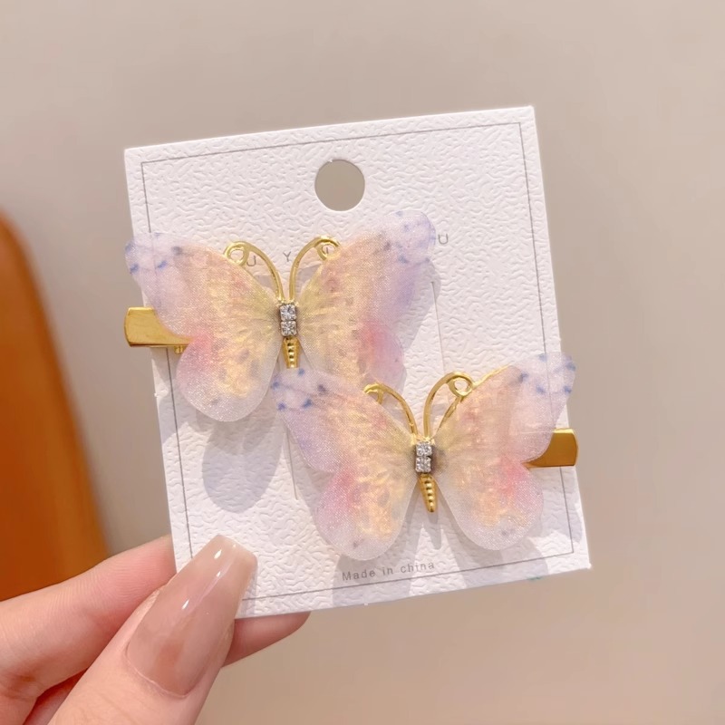 8 ¿ un par de horquillas de mariposa graduadas amarillas y moradas