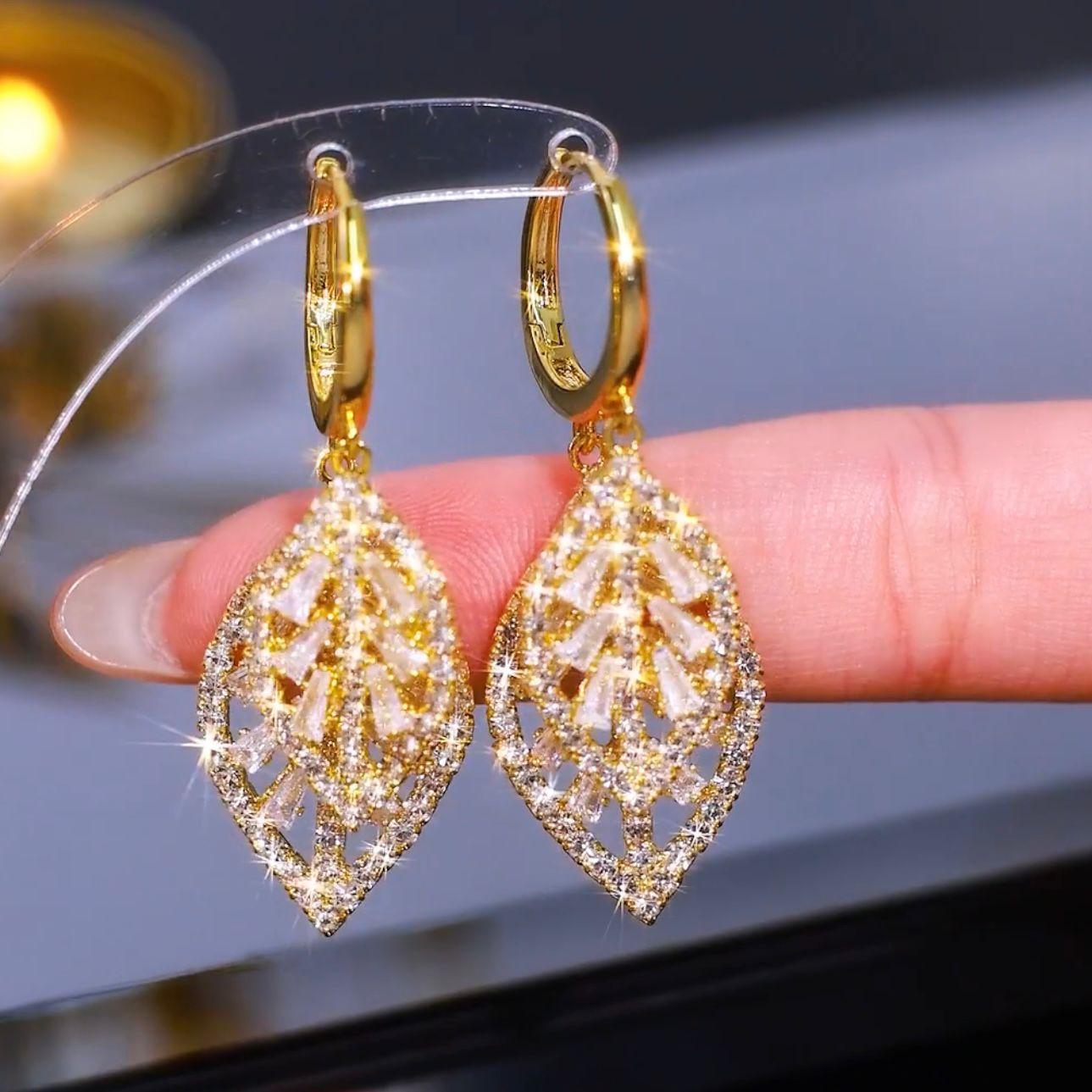 Exquisite and sparkly gold leaf earrings with full diamonds, a new style for 2024, exuding a unique and sophisticated understated luxury.