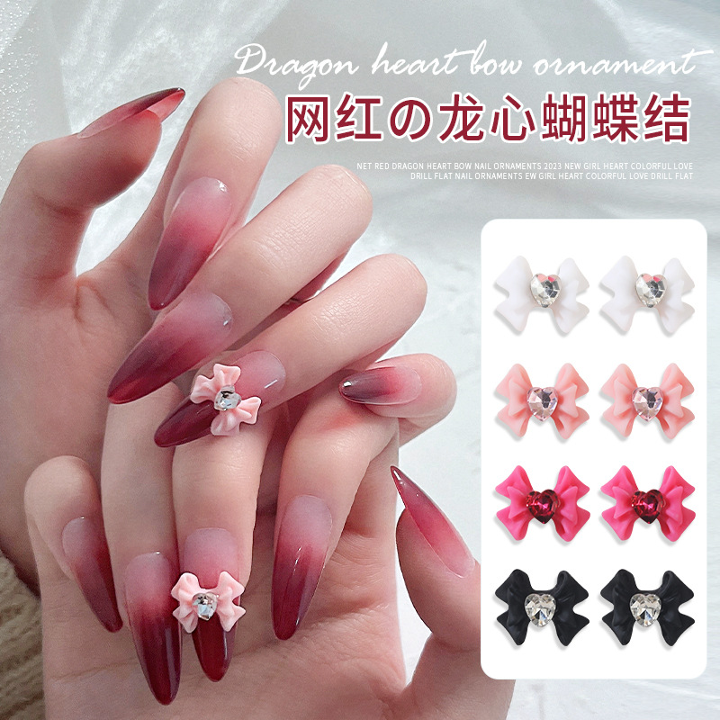 Celebridad en línea dragón corazón arco uñas joyería nueva chica corazón color resina plana tridimensional decoración al por mayor