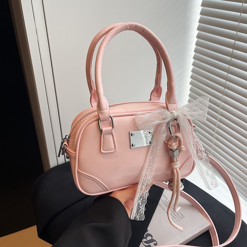 Bolsa de bolos portátil coreana de nicho para mujeres 2026 nueva textura mochila de hombro de estilo extranjero para viajar simple
