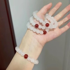 白い玉の手は赤いビーズのブレスレットを刺してシンプルにします。