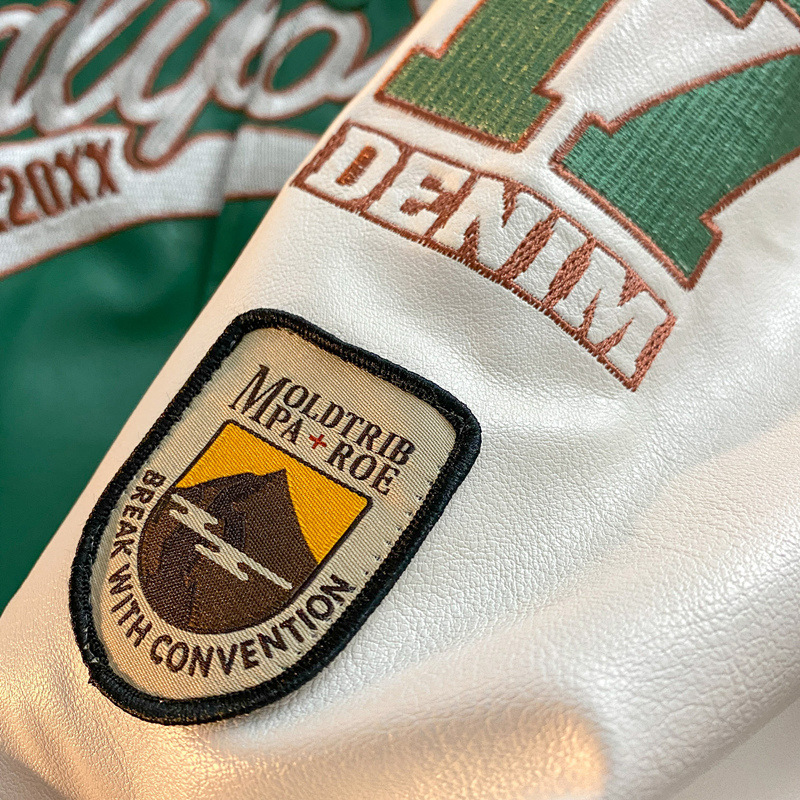 Chaqueta de béisbol de los hombres de primavera y otoño nueva de alto grado Ruan guapo piloto bordado PU cuero costura contraste color chaqueta superior