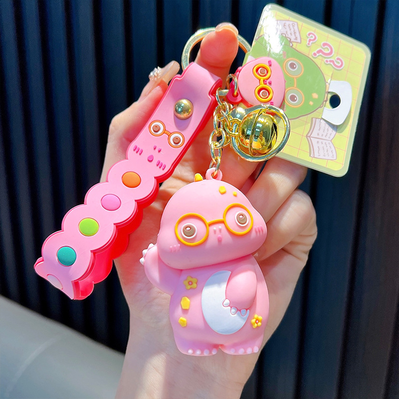 Keychain dinosaurio auténtico lindo bolso colgante de goma blanda llavero de automóvil muñeca pequeña máquina de regalos al por mayor image 7