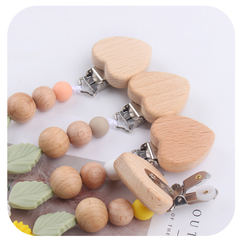 Nuevo clip de chupete de madera de haya de corazón de melocotón de dibujos animados de bebé creativo bricolaje pequeña margarita arco iris gel de mordida de silicona cadena de chupete