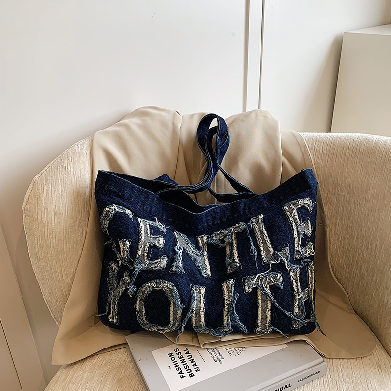 Nueva mochila de hombro de mezclilla retro, bolso de lona con letras de ocio, bolso de viaje artístico para estudiantes