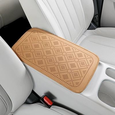 Armrest box pad, with perforated grid pattern, leather