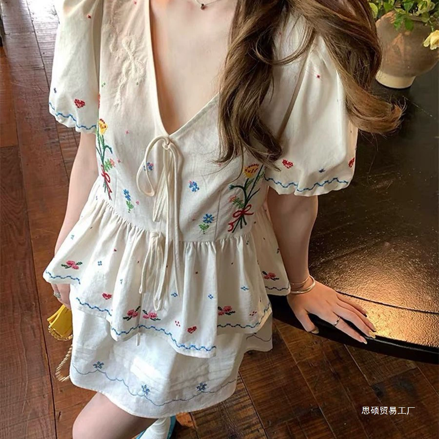 Летний костюм из двух предметов: топ с цветочным вышиванием в стиле французской куклы, уменьшающий возраст, и юбка с высокой талией.